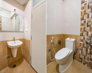 a bathroom with a toilet and a sink at FabExpress Kings Suites in Bangalore