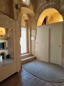 a room with a white door and a window at Stone House in Matera +19 photos