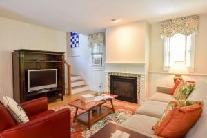 a living room with a couch and a fireplace at Private Patio Walk to Commercial St in Provincetown