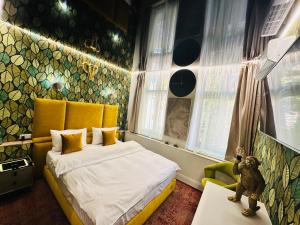 a bedroom with a bed and a teddy bear on a table at Villa & Restaurant Levoslav House in Sibiu