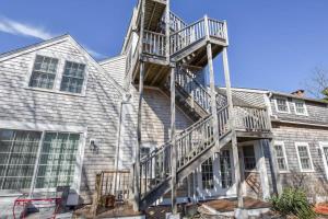 a house with a spiral staircase on the side of it at East End Condo w Beach Access in Provincetown