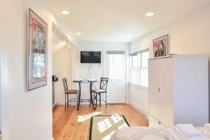a living room with a table and chairs at East End Condo w Beach Access in Provincetown