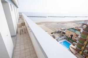 a balcony with a view of the beach at Hotel Capitol in Gatteo a Mare
