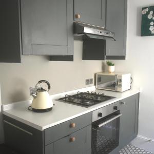 a kitchen with a stove and a tea kettle at Hillside in Bristol