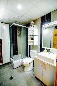 a bathroom with a toilet and a shower and a sink at Park Golden View Hotel Casino in Ohrid