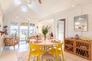 a kitchen and dining room with a table and chairs at Seaside Retreat w Private Beach Landing in Eastham +28 photos