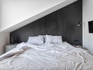 a large white bed in a white room at Luxury Penthouse, Prime Location in Prague