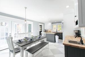 a kitchen with a table with chairs and a sink at Private Pool and Close to Marconi Beach in Wellfleet