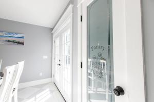 a glass door in a white room with a hallway at Private Pool and Close to Marconi Beach in Wellfleet +45 photos