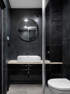 a bathroom with a sink and a mirror at Luxury Penthouse, Prime Location in Prague