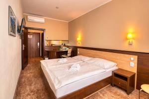 a hotel room with a bed and a desk at Congress Hotel Centrum in Košice