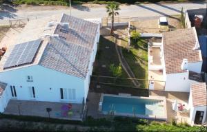 an aerial view of a house with solar panels on its roof at Milagres de Santa Rita in Vila Nova De Cacela +25 photos