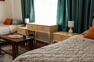 a bedroom with a bed and a desk and a window at Domacinska kuca in Bajina Bašta
