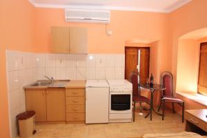 a kitchen with a white oven and a table at Apartment Stari Grad in Trebinje