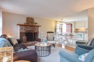 a living room with a couch and a fireplace at Minutes to Oceanside Beaches in Eastham +28 photos