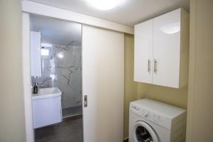 a laundry room with a washer and dryer in it at Two Bedroom Apartment, Mytilene Lesvos in Mytilini