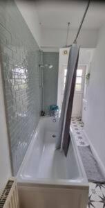 a white bathroom with a shower and a tub at Basement flat in St Leonards in St. Leonards