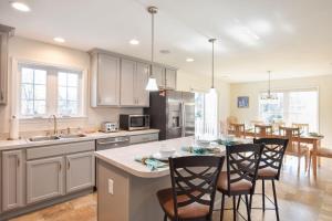 a kitchen with a table and chairs and a dining room at Heated Saltwater Pool Hot Tub in Eastham