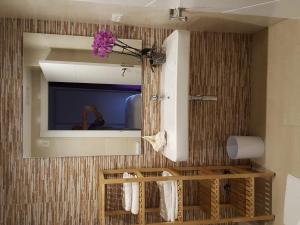 a bathroom with a mirror and a sink at Mandala apARTments in Calafell