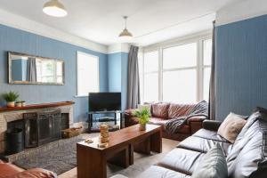 a living room with a couch and a table at Dale House in Kettlewell