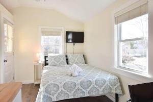 a bedroom with a bed with a stuffed animal on it at Dreamy Cottage for Two Close to Beaches in Eastham