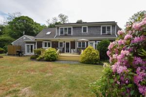 a house with a yard with pink flowers at 4-5 Min to Mill Pond or Nauset Beach in Orleans