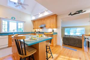 a kitchen with wooden cabinets and a blue counter top at 4-5 Min to Mill Pond or Nauset Beach in Orleans