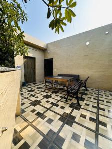 a patio with a ping pong table and a bench at Golden Bed and Breakfast- High Quality Rooms in South Ex-1 D Block in New Delhi