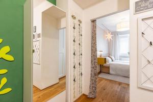 a room with a mirror and a bedroom at Tranquil Haven: Old Town Proximity in Bratislava