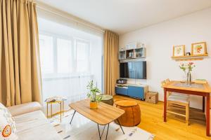 a living room with a couch and a table at Tranquil Haven: Old Town Proximity in Bratislava