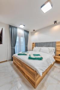 a bedroom with a large bed in a room at Golden Panorama Spa & Wellness in Zlatibor
