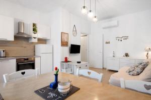 a kitchen and living room with a table and a couch at Bilocale via Rimembranze 6 in Levanto