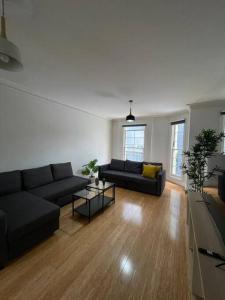 a living room with two couches and a table at 3 Bedroom House Ideal for Family - Ultimo in Sydney