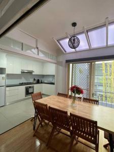 a kitchen and dining room with a wooden table and chairs at 3 Bedroom House Ideal for Family - Ultimo in Sydney
