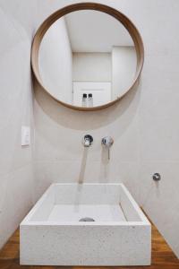 a bathroom with a sink and a mirror at Luxury Duplex by Les Maisons de Charloc Homes in Boulogne-Billancourt