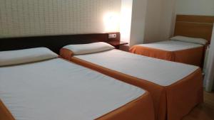 Postel nebo postele na pokoji v ubytování Hotel Alfageme