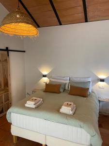 1 dormitorio con 1 cama con 2 toallas en La colina buena - Eco retreat, en Monda