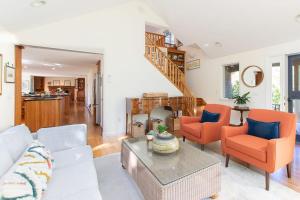 a living room with a couch and chairs at Steps to Skaket Beach in Orleans +28 photos
