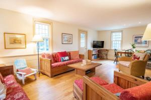 a living room with couches and a table at Fantastic Home by Eldridge Park in Orleans