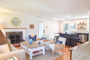 a living room with a couch and a table at Fully Updated Home w Great Outdoor Space in Chatham +23 photos