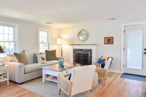 a living room with a couch and a table at Fully Updated Home w Great Outdoor Space in Chatham