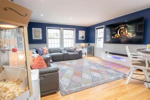 a living room with a couch and a tv at Stellar Home with Hot Tub & Movie Room in Chatham