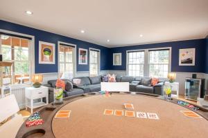 a living room with a couch and a table at Stellar Home with Hot Tub & Movie Room in Chatham +32 photos
