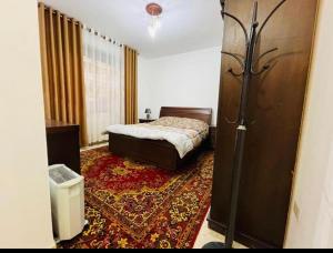 a bedroom with a bed and a rug at Spacious family friendly apartment - Free Barking in Amman
