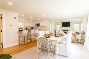 a dining room and kitchen with a white table and chairs at Great Chatham Location Near Beach in Chatham