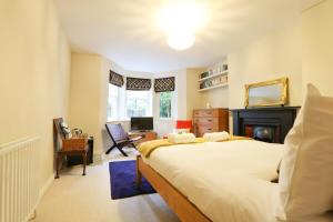 a bedroom with a large bed and a desk at Unique & Homely Suite With Own Access in Bristol