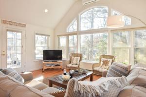 a living room with a couch and a tv at 5-Mins to Forest Beach Dog Friendly in Chatham