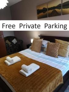 a large bed with towels on it with a free private parking at Dream Destination Apartment in Budapest