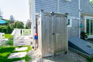 a wooden outhouse in front of a house at Walk to Water Access to Hiking Trails! in Harwich