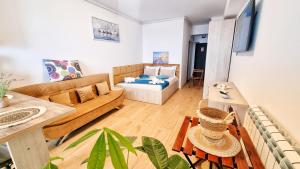 a living room with a couch and a table at Mandala - Studiouri si Apartamente in Eforie Nord